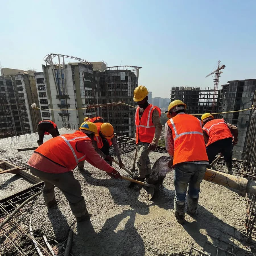 A multi-storey construction site with workers on the slab
